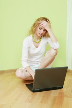 An image of a thoughtful girl with laptop