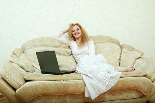 An image of a girl in glasses with laptop