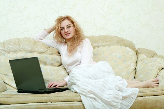 An image of a girl in glasses with laptop 