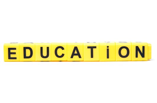 An image of yellow blocks with word ''education''on them