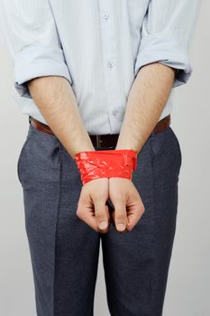 An image of a man with his hands bound