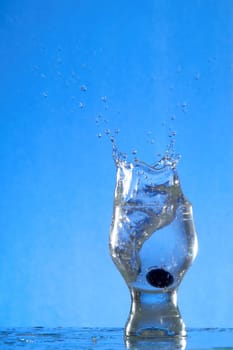 A glass with a drink splashing about