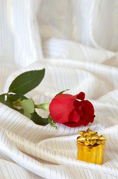 Rose and jewelry on the bed