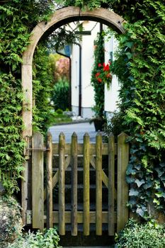 An image of a little house and arch with wicket