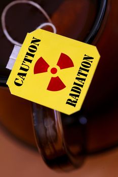 An image of yellow label of tea with sign "radiation"