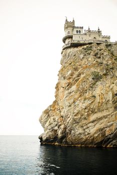 The castle in the Gothic style on cliff above the sea