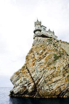 The castle in the Gothic style on cliff above the sea