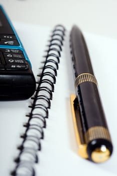 Business Team: phone with pen on page with spiral