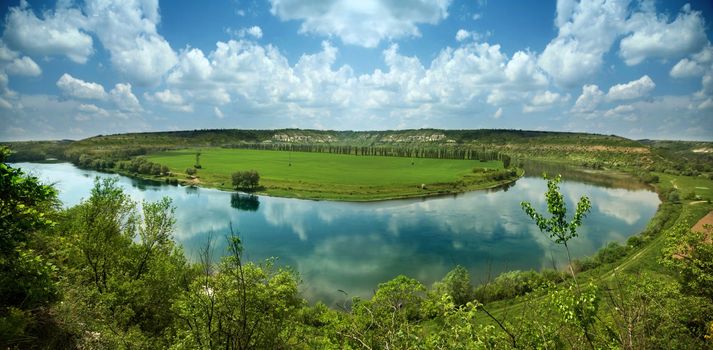 An image of a river under blue sky with clouds