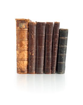 Few old books standing in a row on white background. Clipping path is included