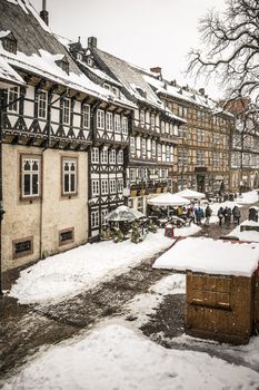 Street with half-timbered houses with snow in winter in Goslar, Germany