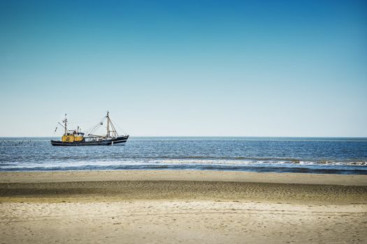 Trawlers in the North Sea on the beach of St. Peter-Ording on a sunny day