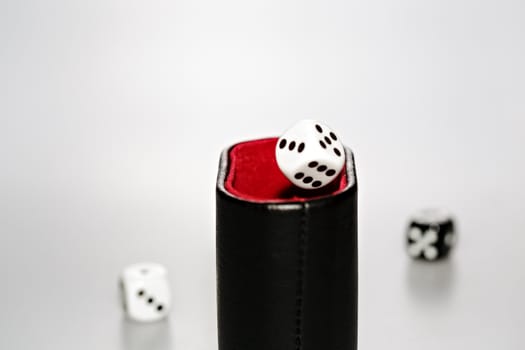 Three dice with dice cup