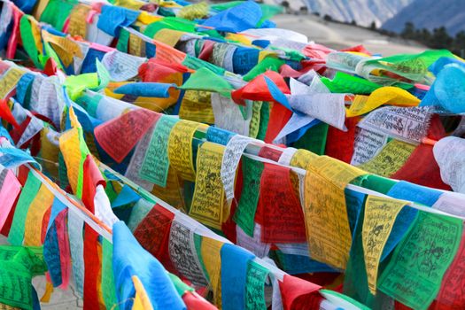 Buddhist tibetan prayer flags flying for background
