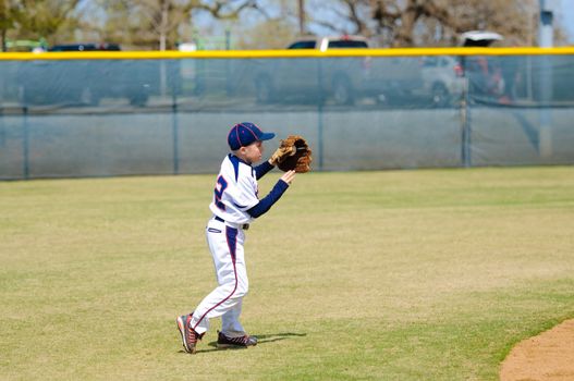 Youth baseball shortstop about to throw the ball.