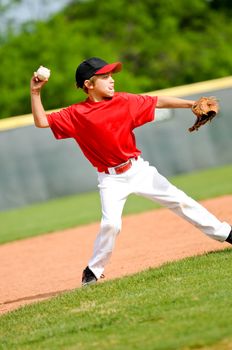 Youth baseball player throwing ball