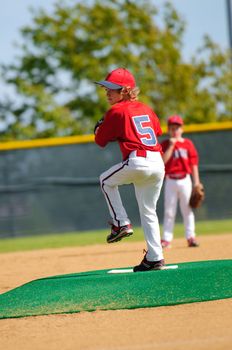 Young baseball pitcher on the pitching mound.