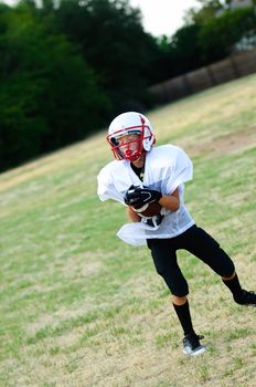 Youth football player catching a football