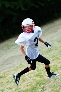 Youth football boy going out for a pass.