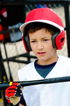 Up-close shot of little league baseball boy about to bat.