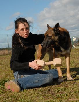 young woman and her purebred belgian sheepdog malinois