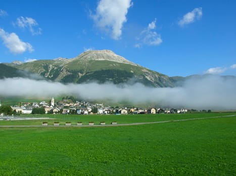 The Swiss mountain small town in clouds