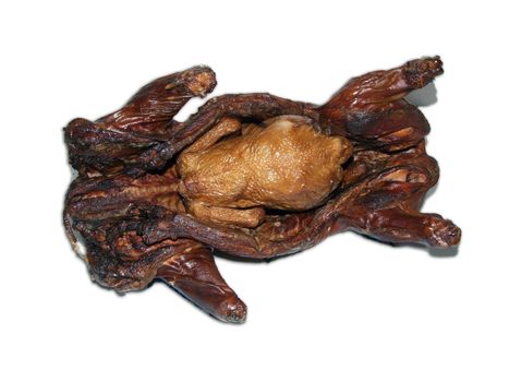 The prepared chicken in a smoked pig isolated