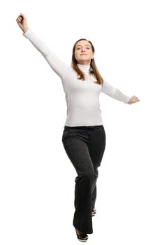 Beautiful young woman stands victory pose. Isolated on white background.