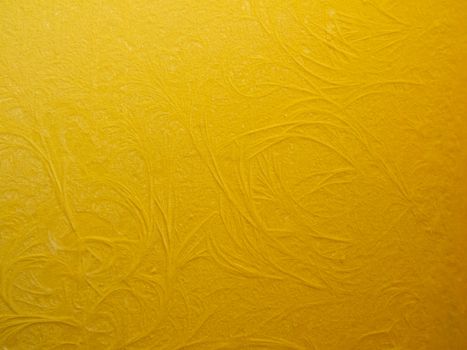 Frosty pattern on a yellow wall