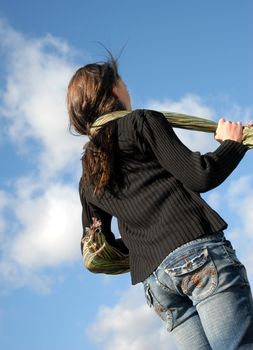 young teenager and her scarf in a blue sky
