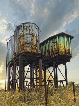 Two rusty old industrial barrels