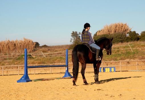 training in dressage for a black horse and her riding girl