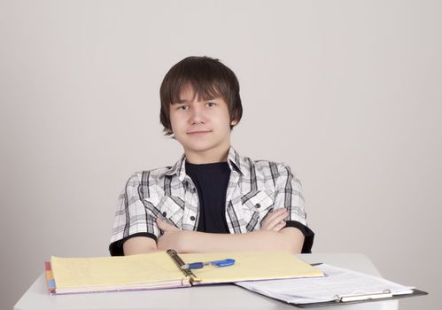 student in exams, sits at the table and reading a book