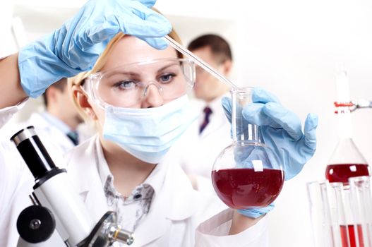 chemist working in the laboratory, mix liquid