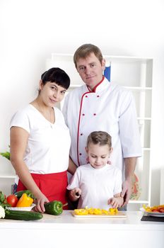 portrait happy family is cooking dinner together