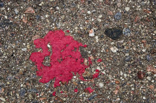 Background of grunge stone asphalt road closeup red paint stain.