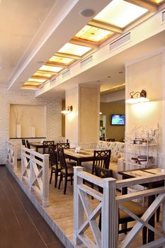 Interior of beautiful modern restaurant with a kind on a number of columns, a vertical shot