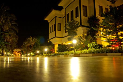 Corner of the house and the shined street during summer night time