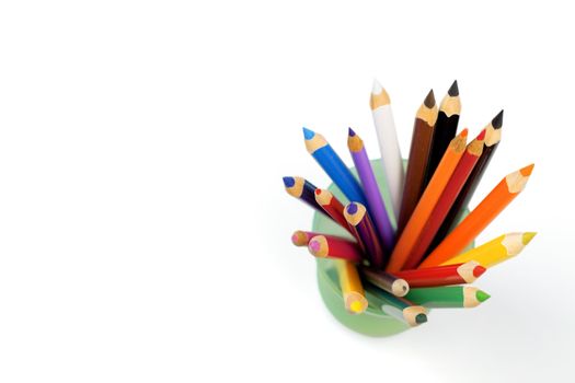 Color pencils in a glass on a white background