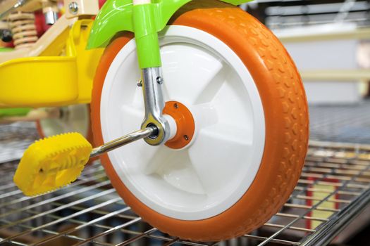 Wheel with pedals of a children's bicycle of a cheerful coloring