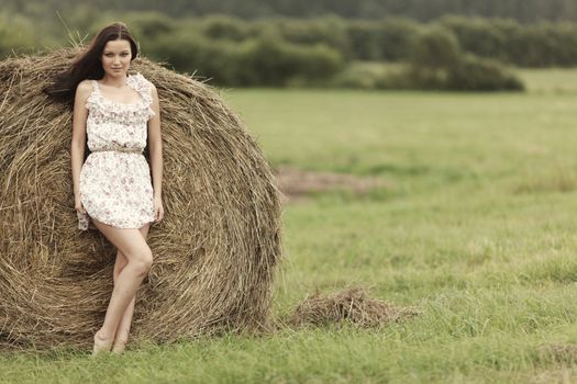portrait of a girl next to haystack