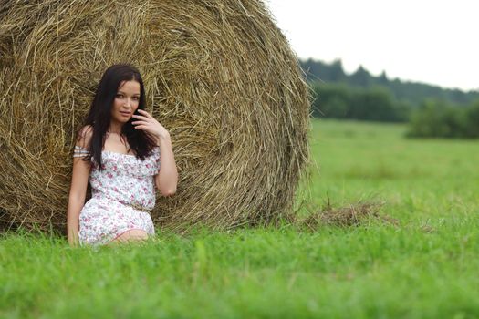 portrait of a girl next to haystack