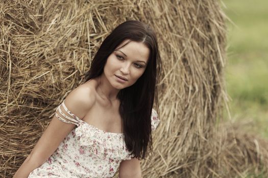 portrait of a girl next to haystack