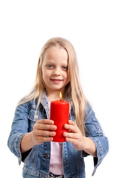 little girl holds a burning candle on white background