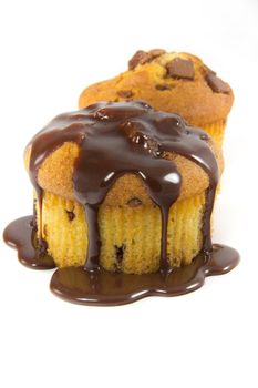 A picture of two muffins with melted chocolate toppings