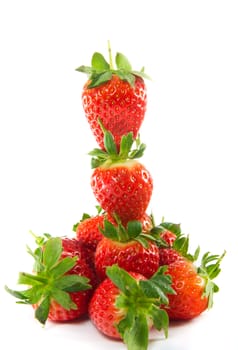 A picture of a tower of strawberries with a ground of strawberries