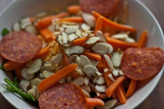 Multiple items in a salad bowl ready to eat.