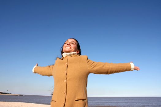 Portrait of a mature woman enjoying the sunlight on a beach.