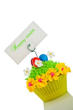 Happy easter cupcake with chocolate egg and cream grass as a meadow with flowers on white background