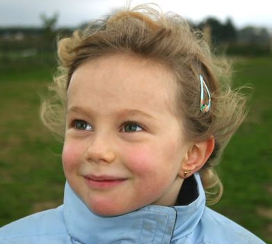 a little girl smiling in the nature